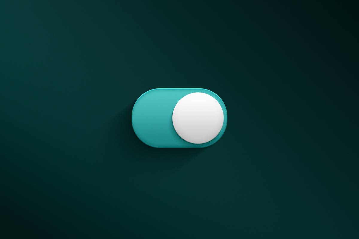 a blue and white button on a green wall